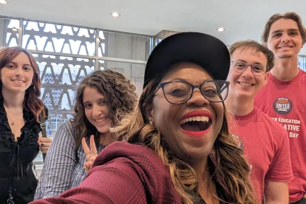Five people smiling for a selfie.